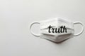 A medical mask with the inscription truth. Space for text. Royalty Free Stock Photo