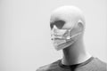 Medical mask mannequin - concept of quarantine and bankruptcy of the clothing trade
