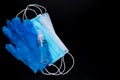 Medical mask, sanitizer and rubber glove for protection against the virus. Isolated on a black background.