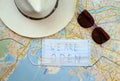 Medical mask with words we are open, sunglasses and hat on a city map of Saint-Petersburg, Russia. Travel during and