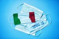 Medical masks on a cinema background. Abstract Italy flag on fabric and inscription coronovirus virus COVID-19