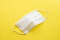 Medical masks of white color on yelliw background for protection against flu and other diseases. Surgical protective mask. Medical