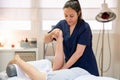 Medical massage at the leg in a physiotherapy center. Royalty Free Stock Photo