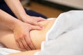 Medical massage at the leg in a physiotherapy center. Royalty Free Stock Photo