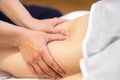 Medical massage at the leg in a physiotherapy center. Royalty Free Stock Photo