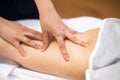 Medical massage at the leg in a physiotherapy center. Royalty Free Stock Photo