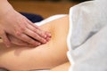 Medical massage at the leg in a physiotherapy center. Royalty Free Stock Photo