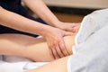 Medical massage at the leg in a physiotherapy center. Royalty Free Stock Photo