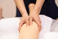 Medical massage at the leg in a physiotherapy center. Royalty Free Stock Photo