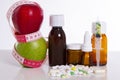 Medical medicine bottles on an isolated white background and apples Royalty Free Stock Photo