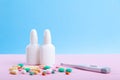 Medical medicines, spray, bottles of nose drops, syrup, vitamins, scattered tablets, capsules Royalty Free Stock Photo
