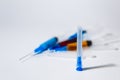 Medical needle on the background of a set of medical syringes with colored liquids inside Royalty Free Stock Photo