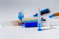 Medical needle on the background of a set of medical syringes with colored liquids inside Royalty Free Stock Photo