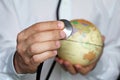 Doctor with stethoscope and globe in his hand Royalty Free Stock Photo