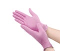 Medical nitrile gloves.Two pink surgical gloves isolated on white background with hands. Rubber glove manufacturing, human hand