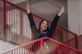 A medical nurse descends the stairs of a modern hospital, showcasing her professionalism, efficiency, and dedication to