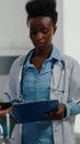 Medical nurse showing medical expertise using tablet computer to specialist black doctor woman Royalty Free Stock Photo