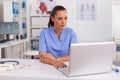 Medical nurse working on laptop Royalty Free Stock Photo
