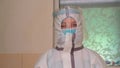 Medical officer in suit of epidemiological protection is on duty at hospital during coronavirus pandemic. Tired woman