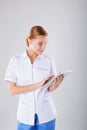 Medical person: doctor portrait. Confident young woman medical professional on white background.