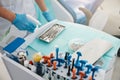 Medical person spraying dental instruments in tray Royalty Free Stock Photo