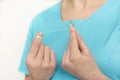 Midsection of dentist in scrubs holding dental floss at clinic