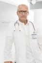 Portrait of confident senior doctor in labcoat standing at hospital Royalty Free Stock Photo