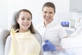 Smiling patient and dentist at dental clinic