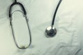 Medical phonendoscope on the background of a medical gown Royalty Free Stock Photo