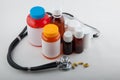 Medical phonendoscope, pills and colorful bottles