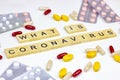 The medical phrase what is coronavirus with pills, capsules and tablets on light background. Ncov epidemic alert concept.