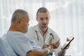 Medical  and physical therapy concept. doctor pointing to screen and explaining information of medical procedure after Royalty Free Stock Photo