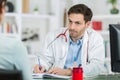 Medical physician doctor listening to patient and taking notes Royalty Free Stock Photo