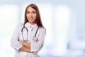 Medical physician doctor woman over blue clinic background. Royalty Free Stock Photo