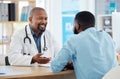 Medical physician talking to his patient. African american patient in a checkup with his doctor. Confident healthcare Royalty Free Stock Photo