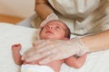 Medical physiotherapist performing a deep cervical fascia on a newborn baby.