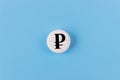 Medical pill with ruble currency sign on a blue background. Rise in the price of medicines. Expensive medicine in Russia