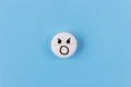 Medical pill with a screaming smiley on a blue background.Painkiller concept Royalty Free Stock Photo