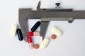 Medical pill in a vernier. Measuring medical pill.