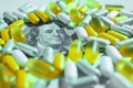 Medical pills lying on top of US Dollar Bill. Big pharma conspiracy theory Royalty Free Stock Photo