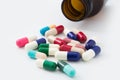 Medical pills out of a toppled from pill bottle Royalty Free Stock Photo