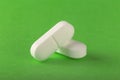 Medical pills white on a green background. The concept of health and medicine. Royalty Free Stock Photo