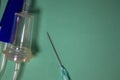 Medical Plastic Intravenous System. Close-up of the Dropper and Needle, Central Venous Conduit on a Blue Background. Medical