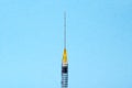 Medical plastic syringe with a needle for beauty injections on a blue background. Therapy concept. Selective focus Royalty Free Stock Photo