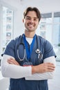 Medical portrait, arms crossed and happy man, doctor or surgeon with confidence, nurse pride and ready for wellness