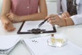 Medical prescription form, capsules and pills are lying against the background of a doctor and patient discussing health Royalty Free Stock Photo