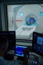 Medical professional conducting brain magnetic resonance imaging on adult man