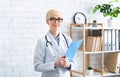 Medical professional. Doctor with tablet in hand in interior of office