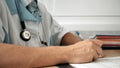 Medical professional doctor writing RX prescription on clipboard. Royalty Free Stock Photo