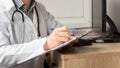 Medical professional doctor writing RX prescription on clipboard Royalty Free Stock Photo